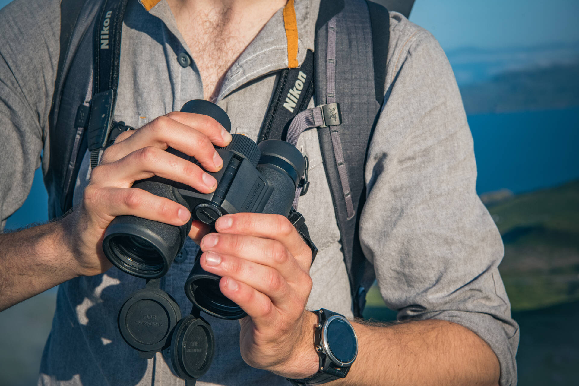 image of binoculars strapped to chest