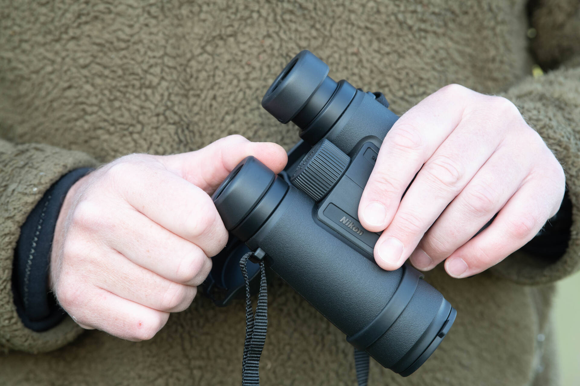 photo of hands holding binoculars